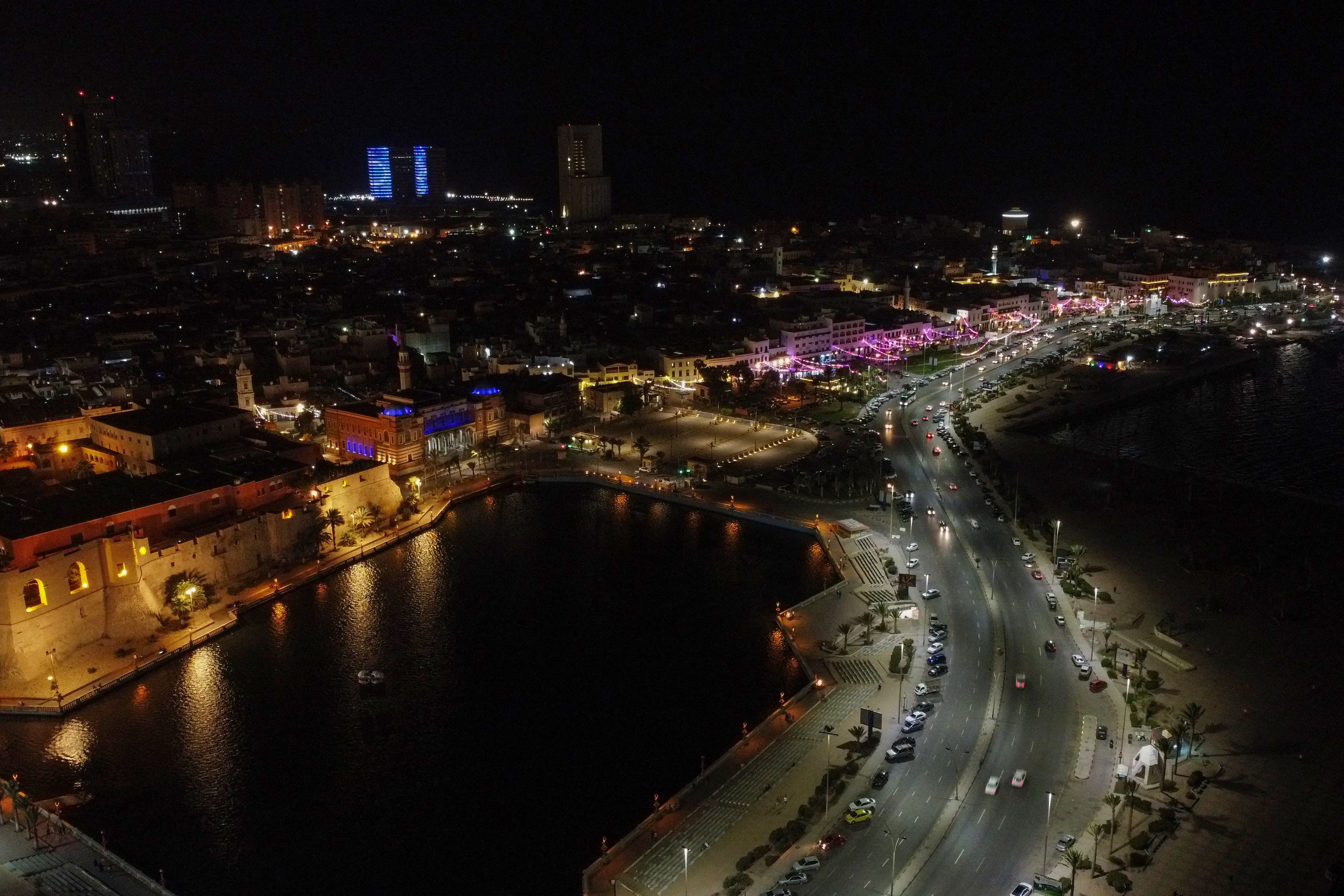 Vue aérienne nocturne d'une route côtière éclairée à Tripoli, avec des voitures près du vieux port, photo d'archives